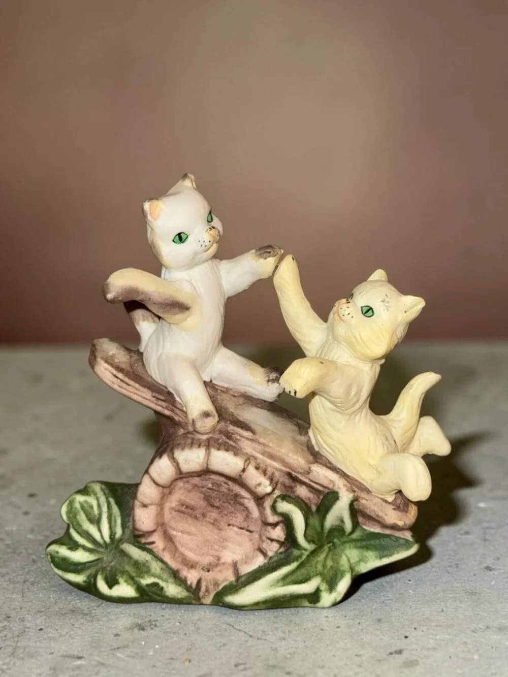 Vintage Ceramic Figurine Of Two Playful Cats On Log With Green Leaves